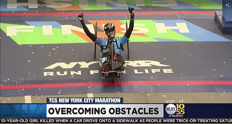 Glenn Hartrick crossing New York Marathon finish line on handcycle in 2016