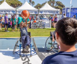 Boy in wheelchair playing basketball at the SDTC Nike Flyease Sport-Zone