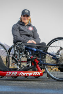 Muffy Davis in wheelchair near a hand cycle