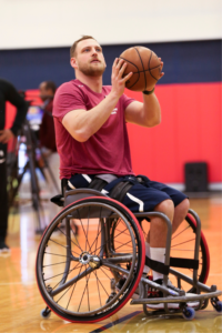 Nate Hinze shooting a basketball in a wheelchair