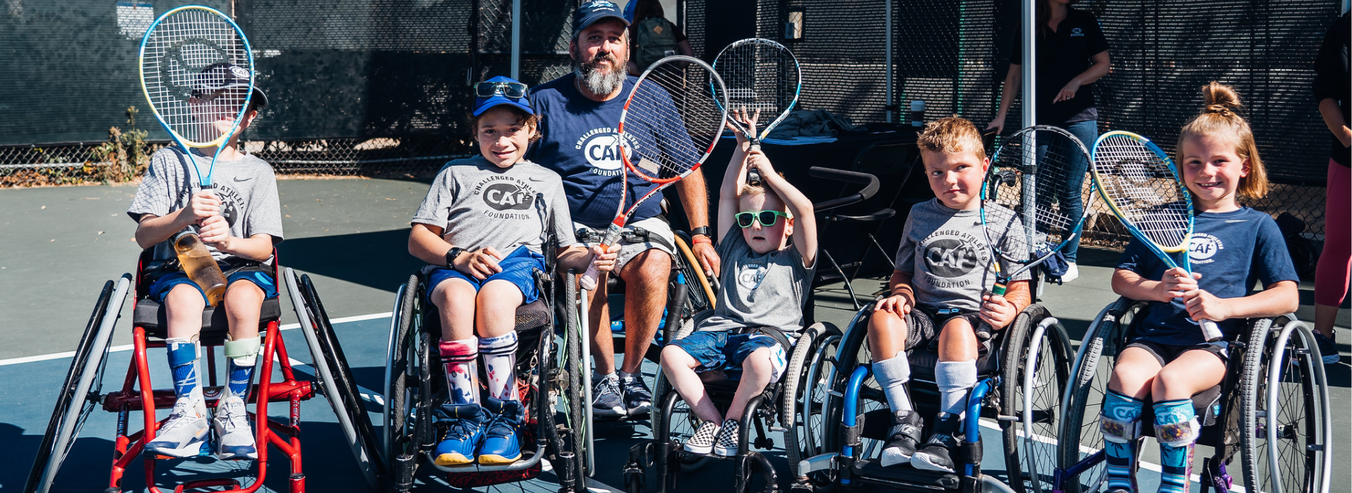 Idaho Tennis Clinic group shot of kids in wheelchairs with tennis rackets