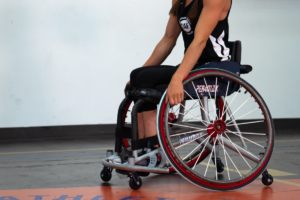 Megan Blunk on basketball court in wheelchair