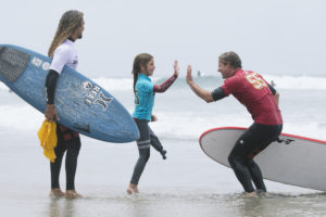 SWITCHFOOT band member high fiving young child on beach