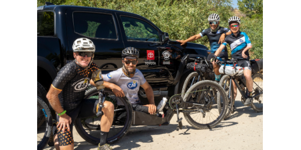 Smoke N Fire cyclist team next to Toyota truck