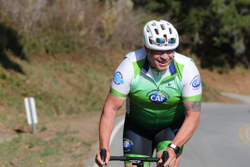 Sully riding a bicycle on the road during the Million Dollar Challenge