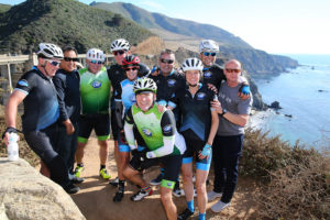 Sully cycling group next to the ocean