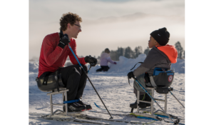 Wilson Dippo with Jackson on sit ski in snow