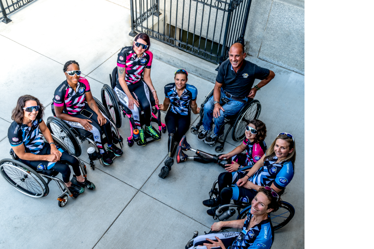 Women's Adaptive Cycling Team sitting in handcycles and wheelchairs