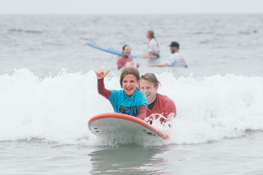 Adaptive athlete participating inYouth Surf Clinic at Switchfoot Bro-Am
