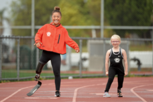 Scout Bassett and Kennasyn Byrd smiling on race track next to one another