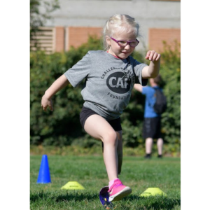 Kenasyn Bird running on prosthetic at CAF Clinic