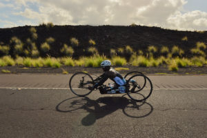 Roderick Sewell riding hand cycle in 2019 Ironman Kona