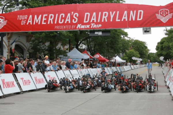 Handcyclists line up under the Tour of America’s Dairyland banner before the race start.