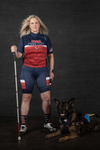 Amy Dixon in Team USA Paratriathlon kit with guide dog