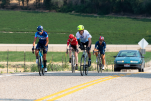 CAF cyclists riding in road race on upright bicycles
