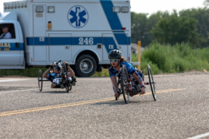 CAF athlete Lera riding in road race on handcycle