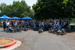 Group of adaptive cyclists pose for photo before CAF Cycling Clinic