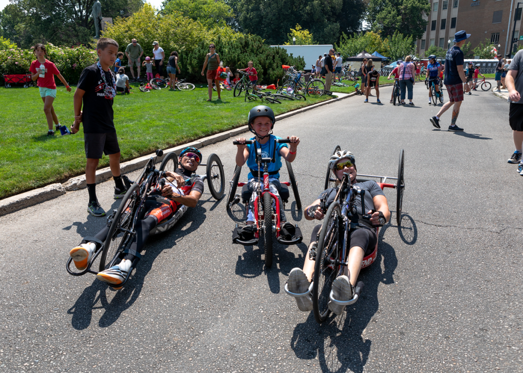 Muffy Davis and Will Groulx with CAF Idaho athlete Brooklyn Gossard on handcycles