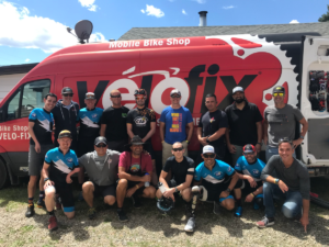 2019 Leadville CAF Athletes and Crew posing for photo in front of Velofix van