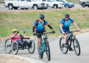 Scott Pederson with 2 CAF Idaho Cycling Club riders on mountain bikes and trikes