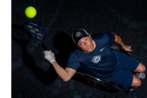 David Wagner in wheelchair hitting tennis ball