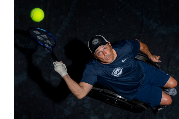 David Wagner in wheelchair hitting tennis ball