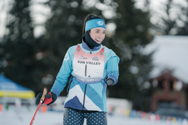 A sit-ski athlete with a physical disability races across packed snow during a Nordic skiing event in Idaho.