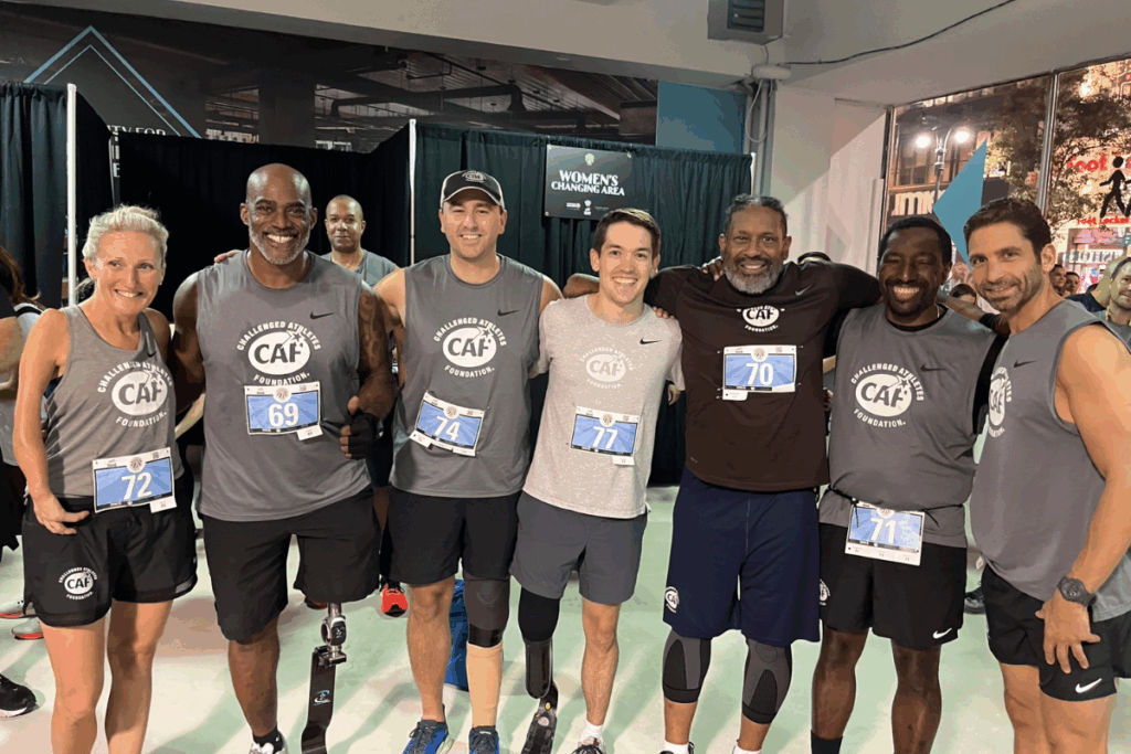 CAF athletes and supporters gather for a group selfie before the Empire State Building Run-Up, smiling and celebrating together.
