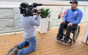 Justin Phongsavanh being interviewed on the boat ride to Antarctica