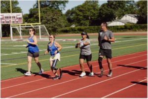 male and female conditioning session on turf track