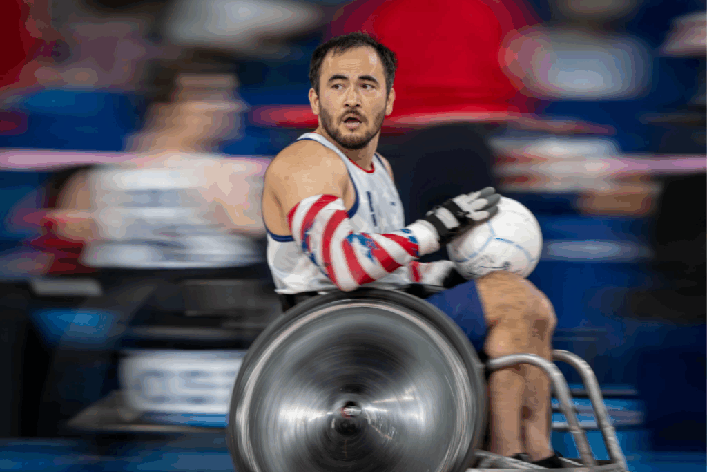 Team USA wheelchair rugby athlete Chuck Aoki moves down the court holding the ball during a fast-paced Paralympic match.