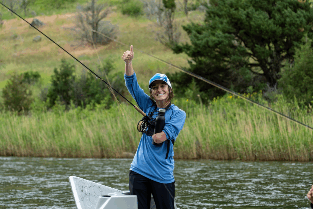 CAF athlete ambassador Dani Aravich in idaho smiling on a boat at a fly fishing clinic