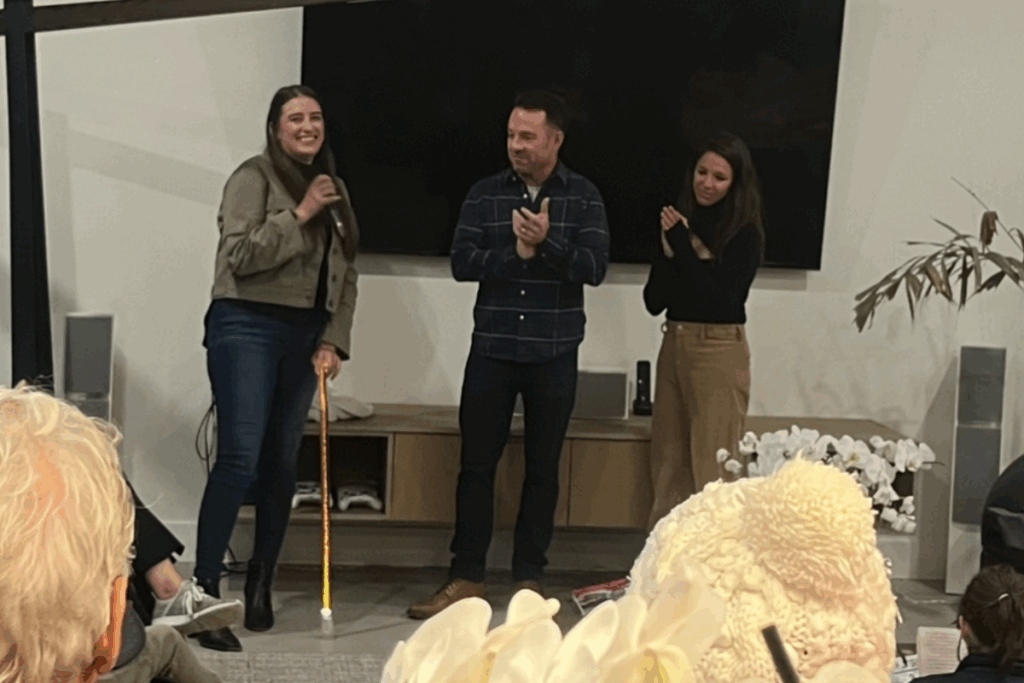 CAF grant recipient Allie Grover receiving a grant with two other people presenting smiling together