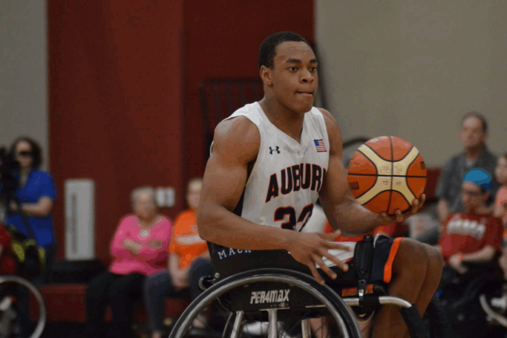 Auburn University wheelchair basketball player, Mack Johnson, dribbles down the court during a game.