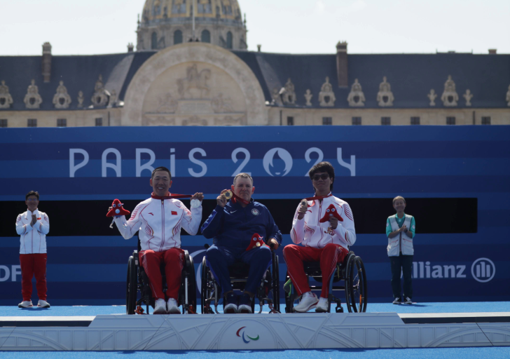 Medal ceremony at the Paris 2024 Paralympic Games featuring Team USA and Team China wheelchair athletes on the podium.