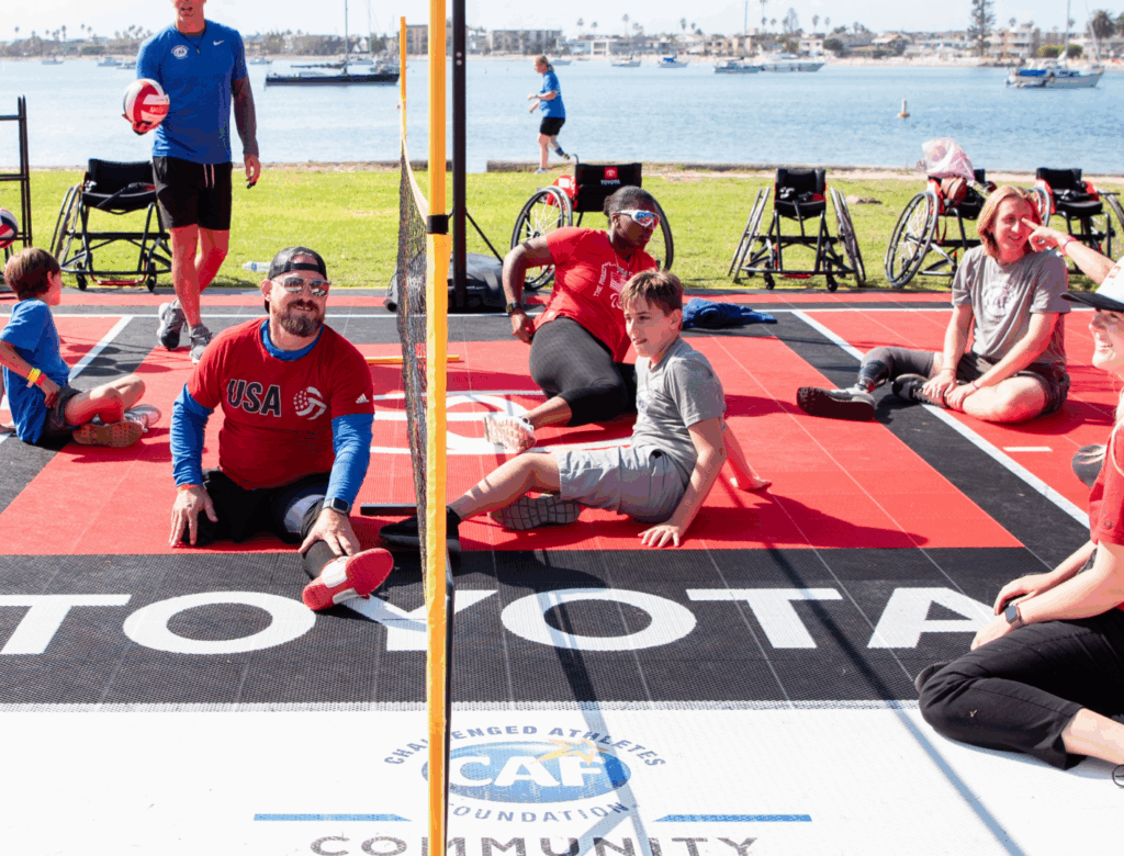 Travis Ricks playing sitting volleyball on sport court at SDTC
