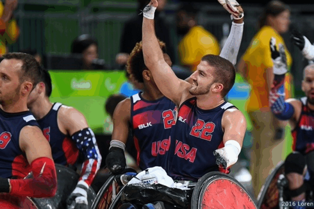 Team USA wheelchair rugby player raises his arm in celebration during competition