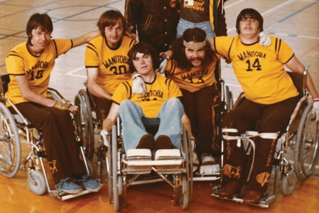 Historic photo of a Manitoba wheelchair rugby team posing together in yellow jerseys