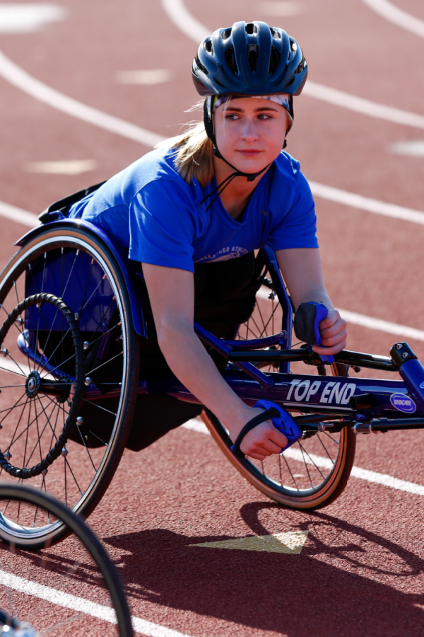 Abby Dunn in racing wheelchair on track at a 2020 High School Adaptive Sports Clinic
