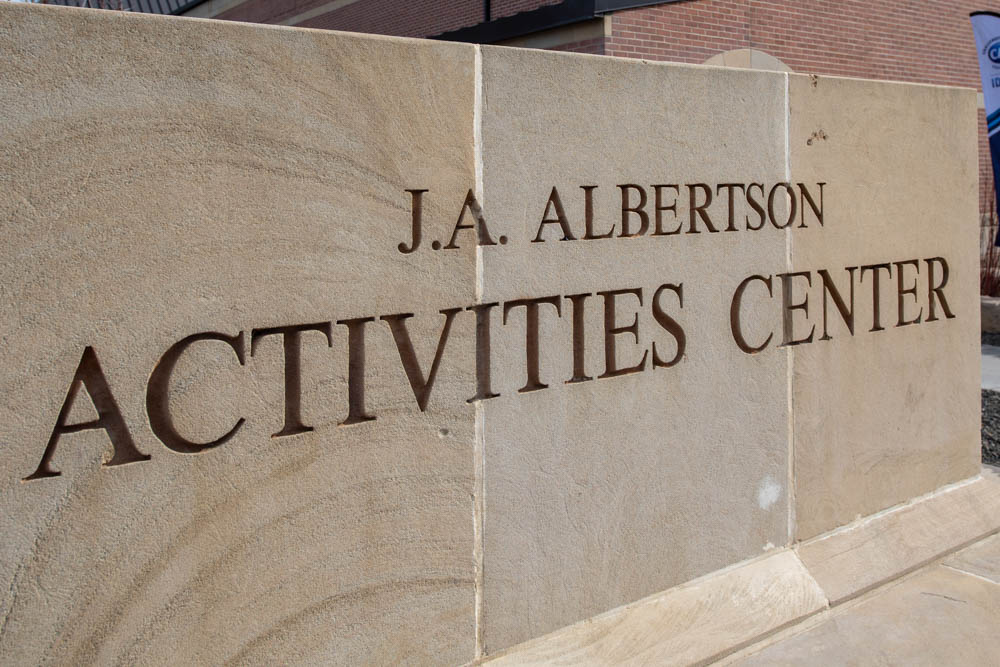 Stone wall with "J.A. Albertson Activities Center" engraved on it.