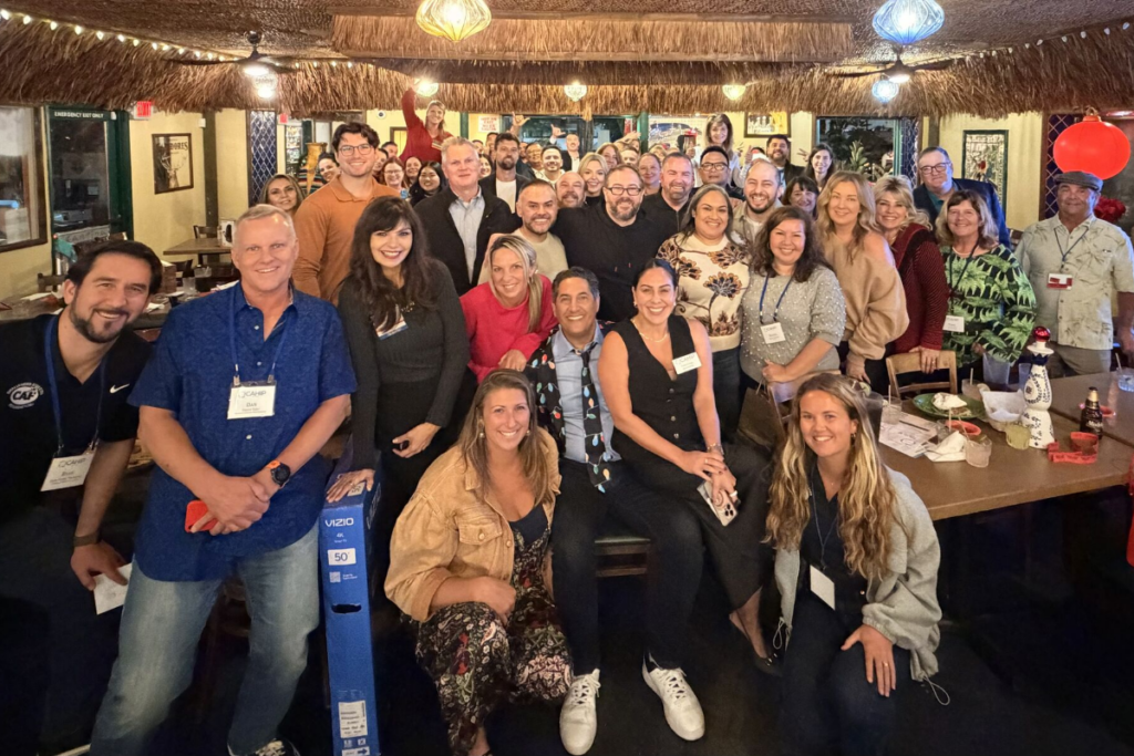 Community members gather for a group photo during a fundraising event supporting adaptive sports opportunities.