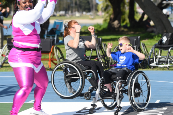 Brantley Volpel participates in an adaptive activity while seated in his wheelchair alongside a coach and another athlete with a physical disability during a Challenged Athletes Foundation program.