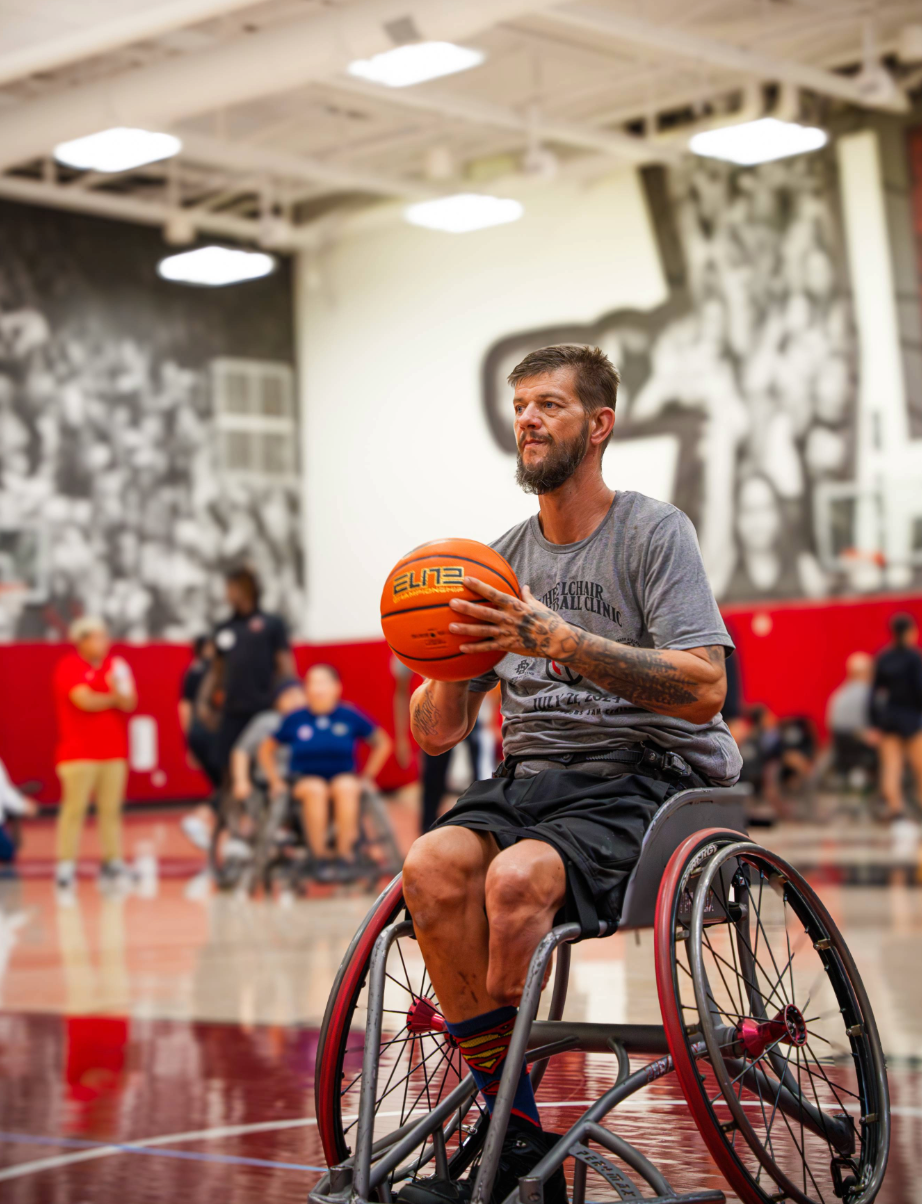 Athletes at a wheelchair basketball clinic on the court at SDSU