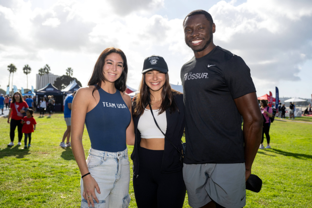 Beatriz Hatz stands with fellow Paralympians and adaptive sport advocates at an outdoor CAF event.