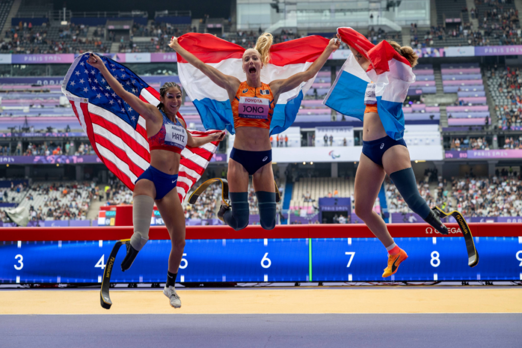 Beatriz Hatz celebrates with fellow medalists on the track during the 2024 Summer Paralympics.