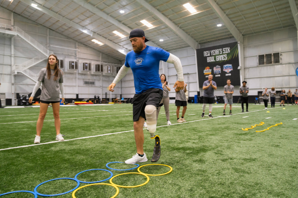 Adaptive athlete practices footwork through agility rings during a running skills session at the CAF and Össur Running and Mobility Clinic.