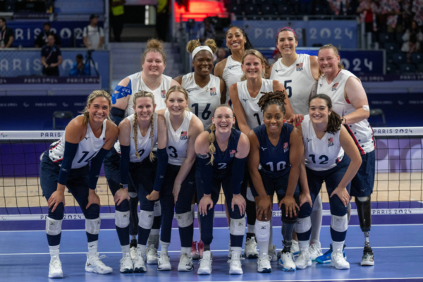United States women's sitting volleyball team posing for a group photo at the Paris 2024 Paralympic Games.