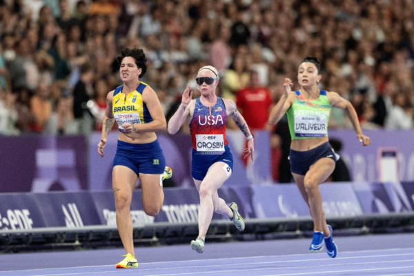 Paralympic sprinters competing in a track race during the Paris 2024 Paralympic Games.