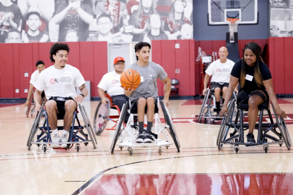 Participants maneuver sports wheelchairs while practicing wheelchair basketball drills during a Challenged Athletes Foundation adaptive sports clinic.