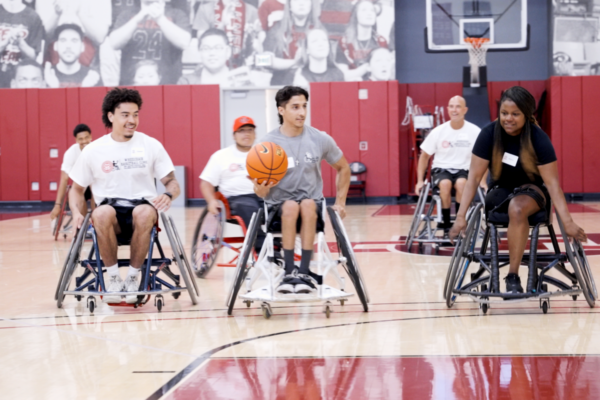 Participants maneuver sports wheelchairs while practicing wheelchair basketball drills during a Challenged Athletes Foundation adaptive sports clinic.